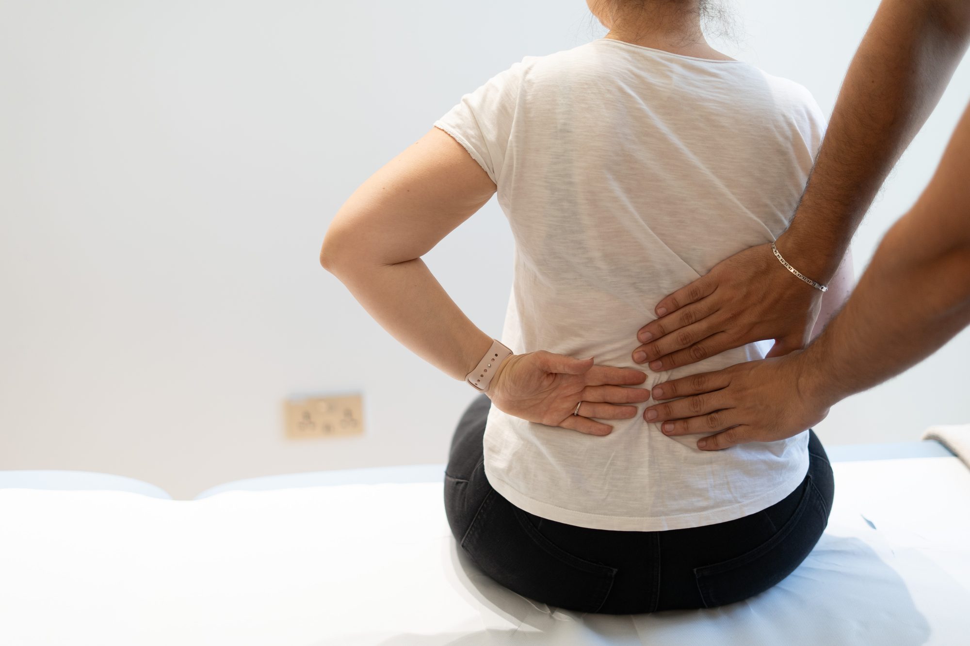 Kinetika physiotherapist treating a patient with back pain at Kinetika Dubai