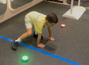 Child doing a movement and reaction exercise during a physiotherapy session at KINETIKA Dubai Hills